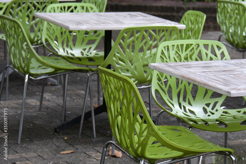chairs and tables at the oudoor cafe, with green unusual design