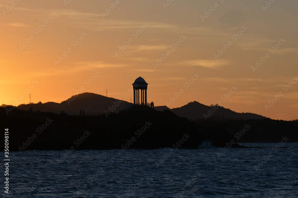  buildings at the seaside coast, at the sunset