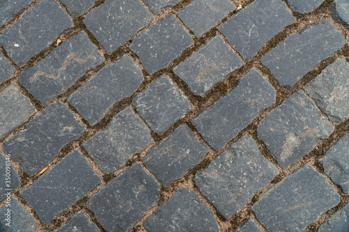 Background image of texture of a pedestrian road paved with paving stones