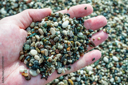 sea pebbles in men's hands
