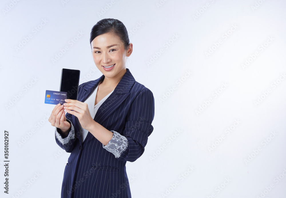 business woman showing plastic credit card and mobile phone. concept business, shopping online, internet, blanking business woman showing plastic credit card and mobile phone. concept business, shopping online, internet, blanking