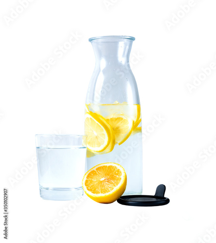 transparent carafe with water and lemon. A glass of water. Isolate