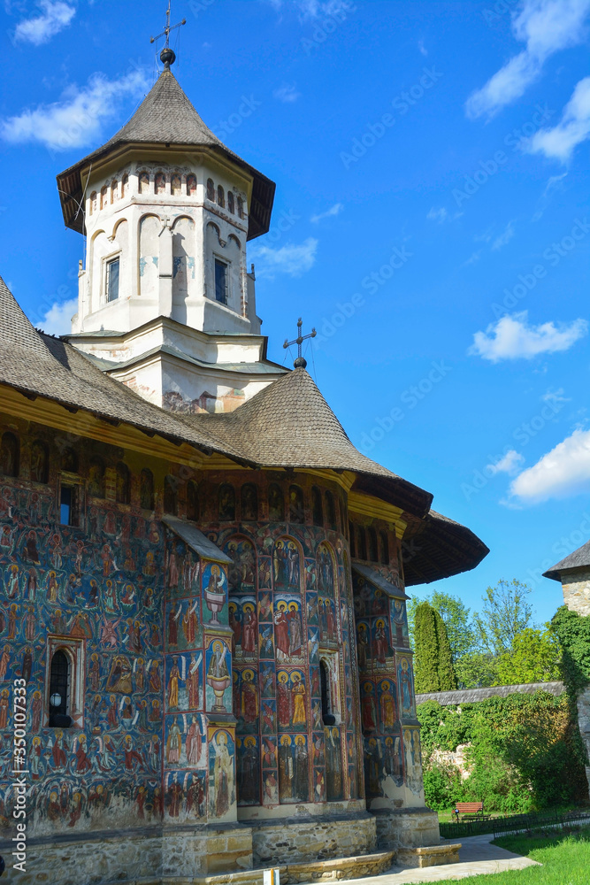 Facade of the Moldovita Monastery located in the Vatra Modovitei region south of Bucovina, Romania, Europe. Moldovan architectural style and paintings of Byzantine influence with bucovin colors Facade of the Moldovita Monastery located in the Vatra Modovitei region south of Bucovina, Romania, Europe. Moldovan architectural style and paintings of Byzantine influence with bucovin colors