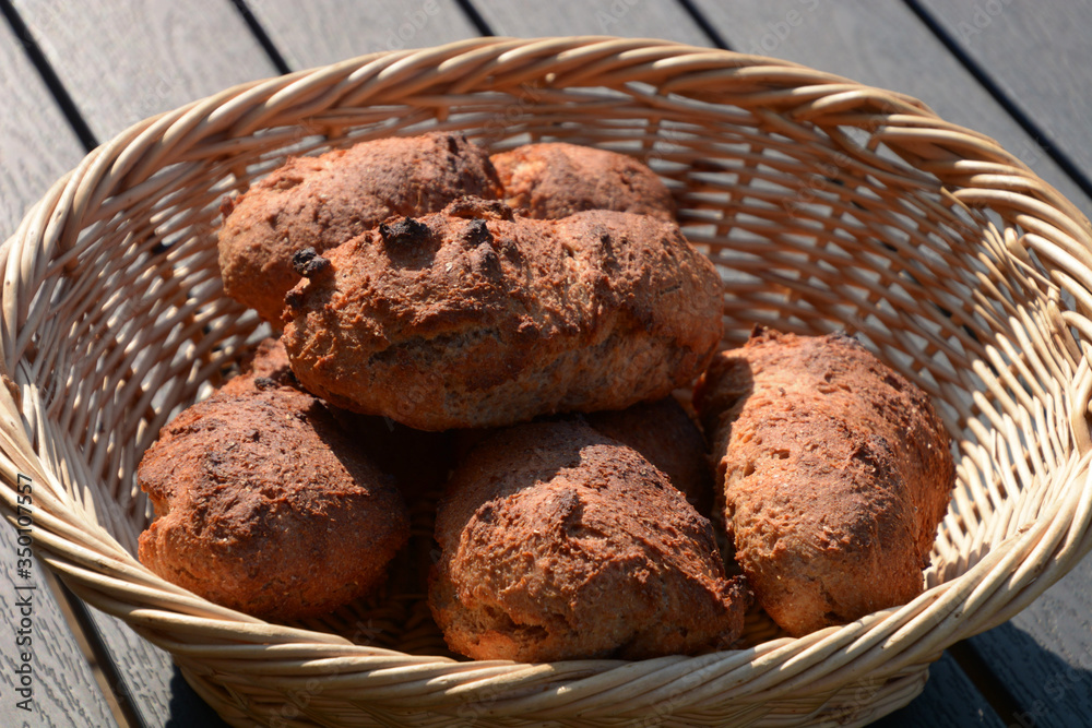 crispy baked hulled wheat rolls in wooden bio basket crispy baked hulled wheat rolls in wooden bio basket