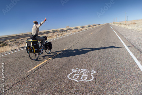 Man Riding Bicycle on Historic Route 66 in New Mexico, USA.