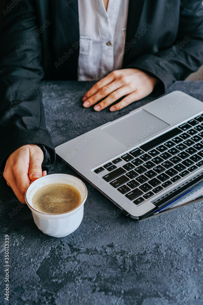 girl typing on a laptop keyboard, next is a mug of coffee girl typing on a laptop keyboard, next is a mug of coffee