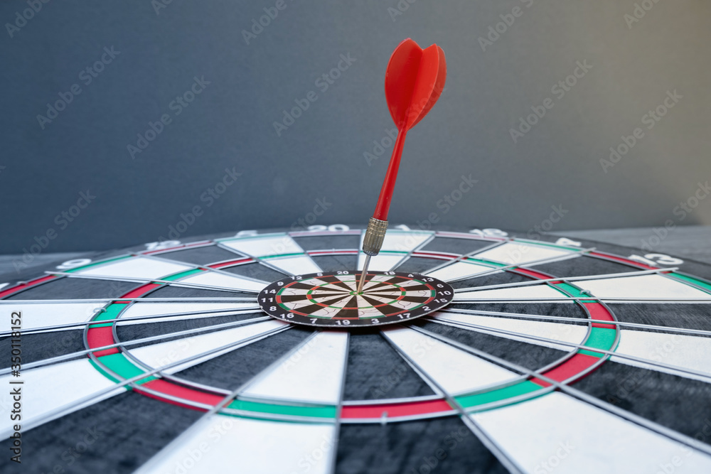 The arrow in the middle of the dartboard Demonstrate the concept of a successful business goal The arrow in the middle of the dartboard Demonstrate the concept of a successful business goal
