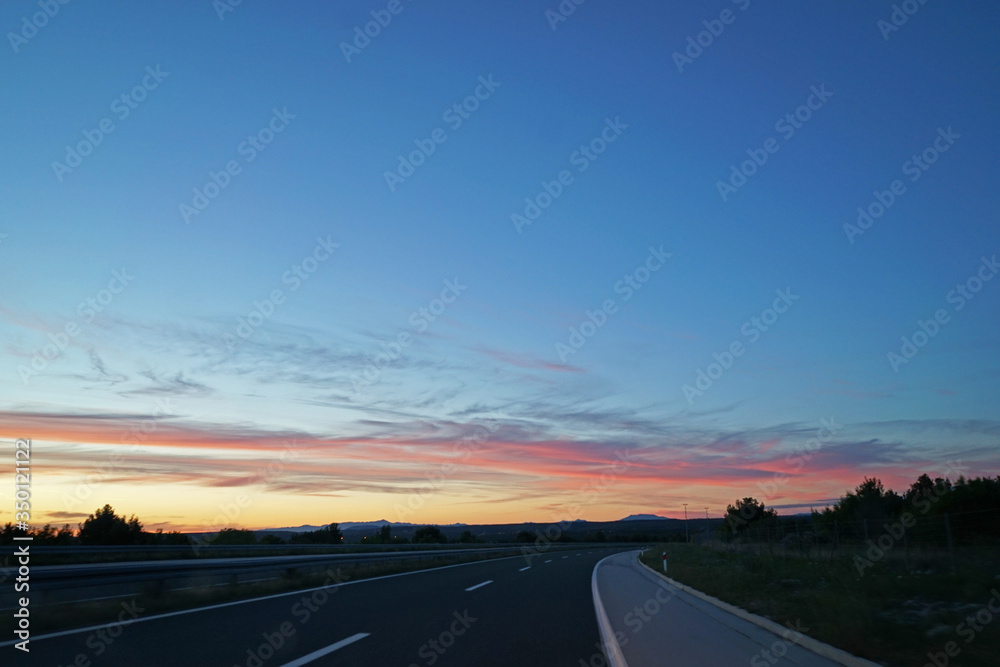 Beautiful roadside scenery landscape with sunset moment view from front car windshield