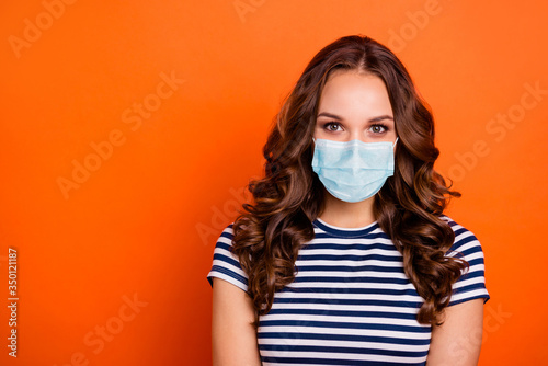 Close up photo amazing pretty lady kindhearted sincere green eyes wear casual striped white blue t-shirt quarantine protection facial mask isolated orange bright background