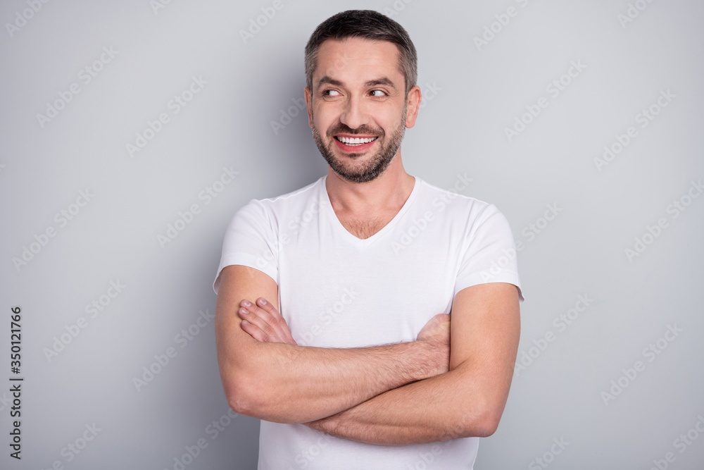 Close-up portrait of his he nice attractive cheerful cheery curious muscular guy folded arms creating new idea isolated over light grey pastel color background