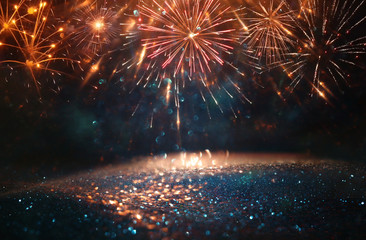 abstract gold, black and blue glitter background with fireworks. christmas eve, 4th of july holiday concept