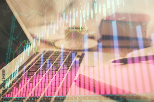 Double exposure of financial chart drawing and desktop with coffee and items on table background. Concept of forex market trading