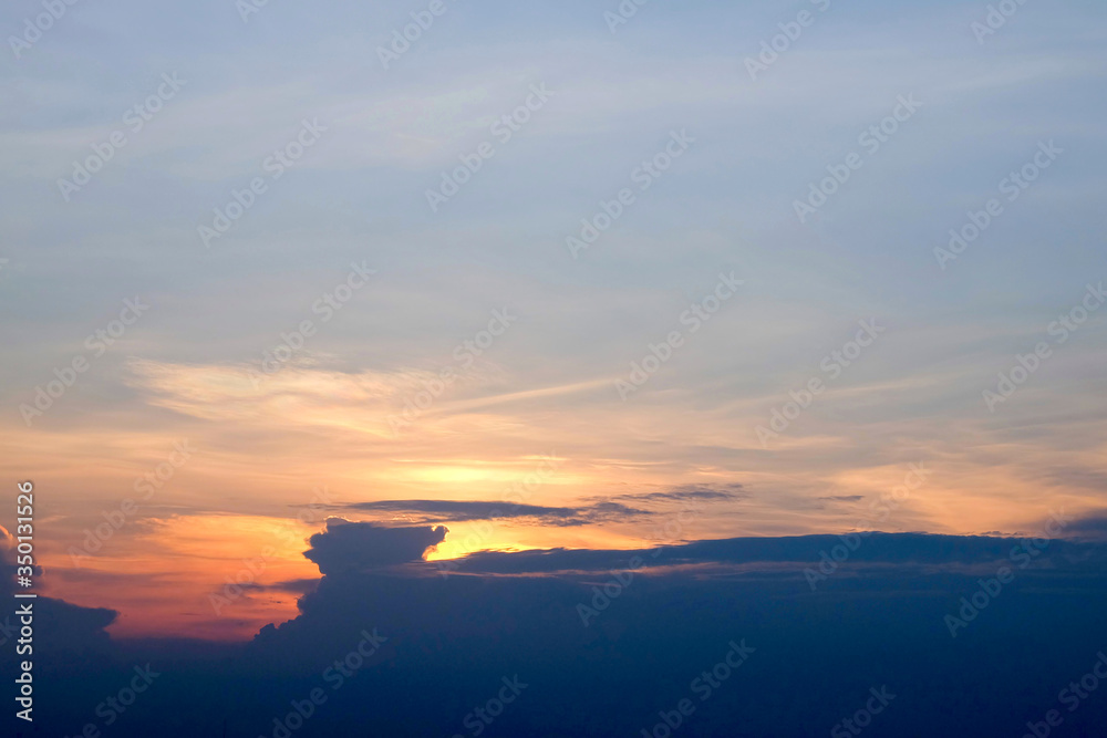 Obraz premium Sunset sky with dramatic clouds and beautiful dark blue cloud.
