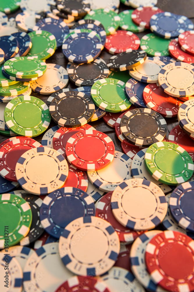 Gambling chips on dark wooden desk. Gambling chips on dark wooden desk.