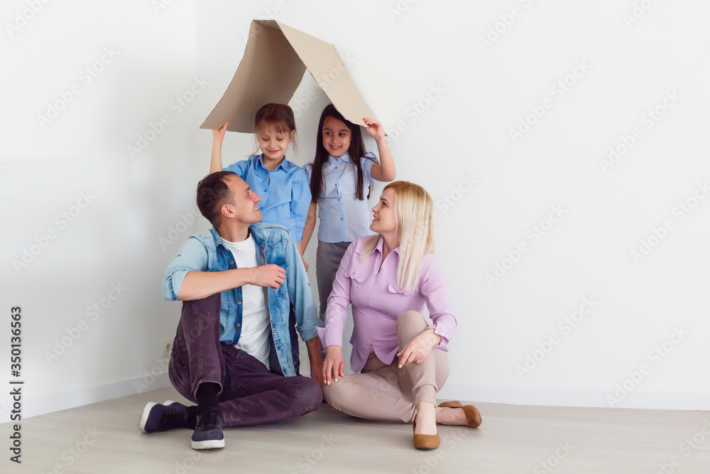 concept housing a young family. Mother father and child in new house with a roof concept housing a young family. Mother father and child in new house with a roof