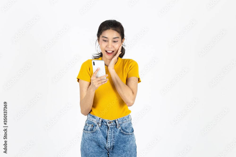 Surprised young Asian woman in casual clothes using mobile smart phone over white isolated background. Surprised young Asian woman in casual clothes using mobile smart phone over white isolated background.
