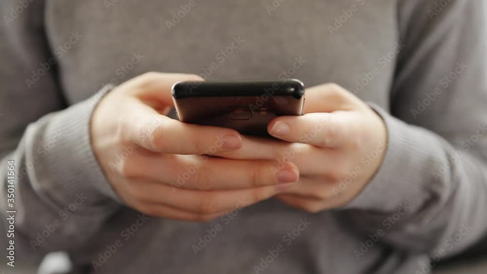 Close up 4k video of a young woman using a smartphone at home.