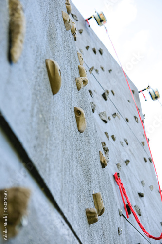 Outdoor climbing wall, an artificially constructed wall with grips for hands and feet.
