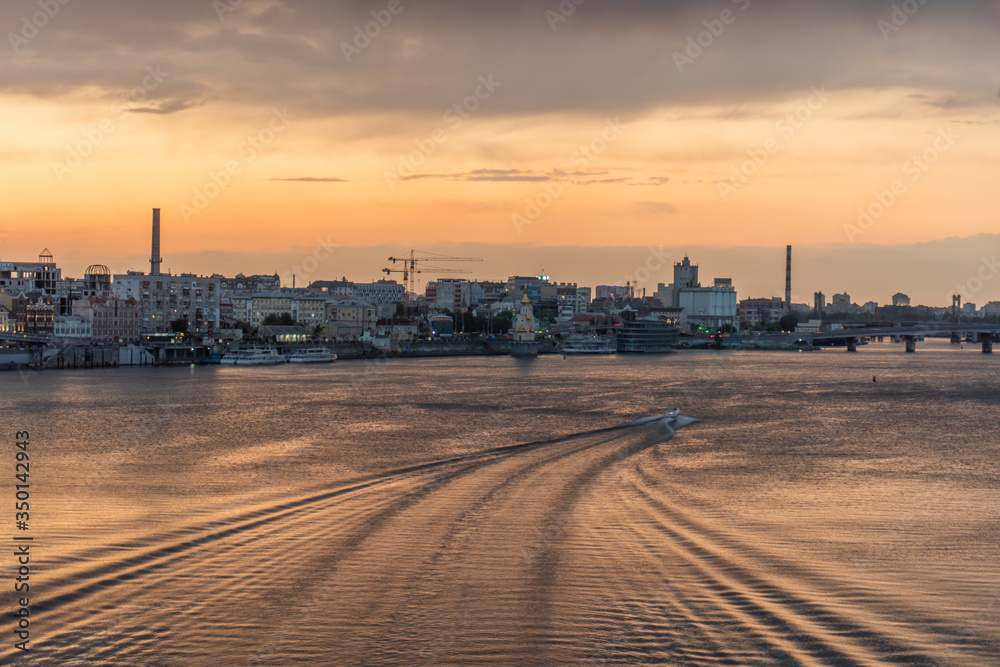 Stunning, amazing, beautiful sunset in the city, panorama of the historical region in Kyiv, Dnipro river