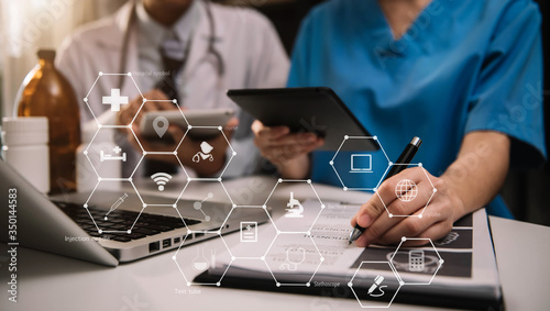 Doctor team working together on digital tablet healthcare doctor technology tablet using computer in a modern office.