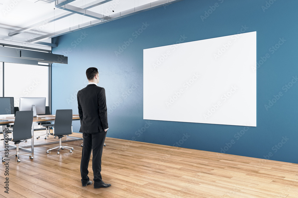 Businessman standing in modern office interior Businessman standing in modern office interior