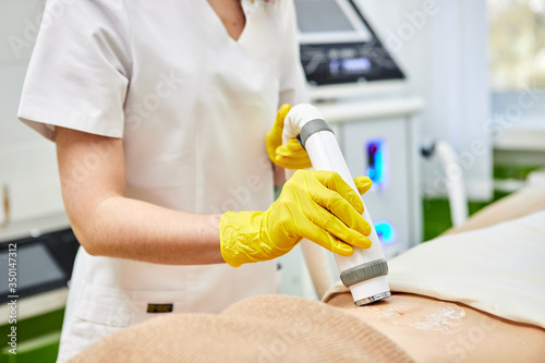 Rf skin tightening, belly. Hardware cosmetology. Ultrasound cavitation body contouring and sculpting treatment, anti-cellulite and anti-fat therapy in beauty salon.