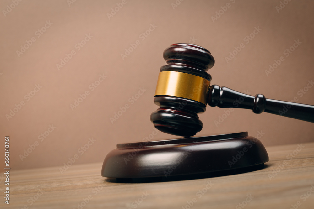 Symbol of law and justice on wooden table in lawyer office Symbol of law and justice on wooden table in lawyer office