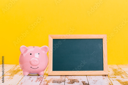 pink piggy bank on a yellow background, space for text. Finance, saving money, crisis. Business or Retirement Savings