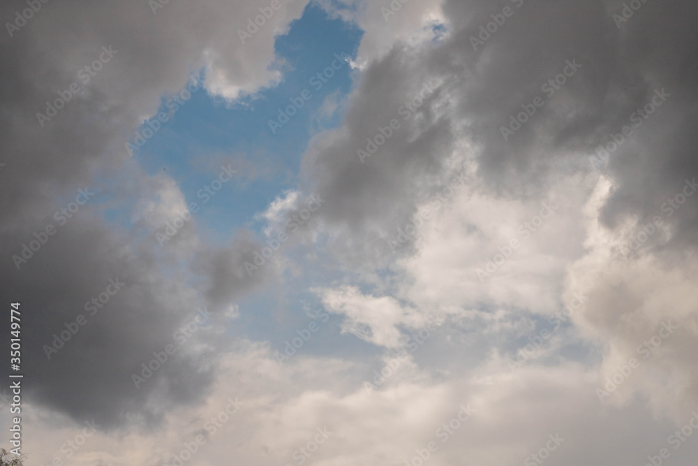 blue sky with white and grey rain clouds blue sky with white and grey rain clouds