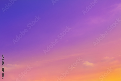 Beautiful colored clear sky and small fluffy clouds in twilight time. Colorful background from outdoor natural sunset with copy space. © Krisda
