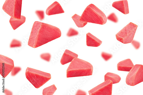 Falling raw tuna steak, fish isolated on white background, selective focus