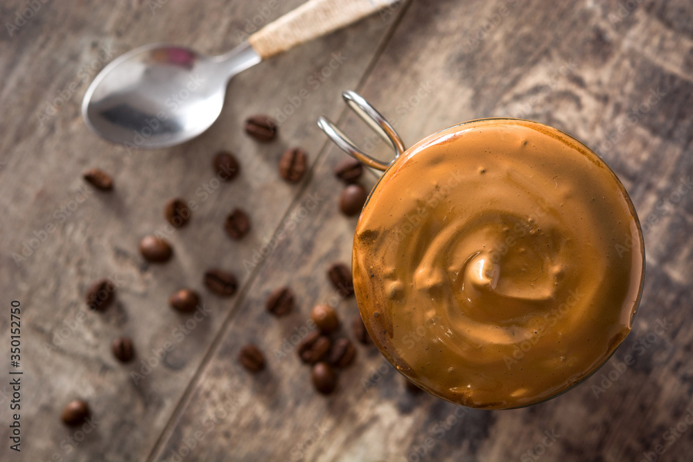 Creamy iced dalgona coffee on wooden table. Top view. Copy space Creamy iced dalgona coffee on wooden table. Top view. Copy space