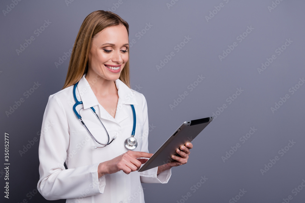 Close-up portrait of nice attractive cheerful blonde girl doc therapist using gadget wireless connection consulting advice remotely distance isolated over grey violet pastel color background Close-up portrait of nice attractive cheerful blonde girl doc therapist using gadget wireless connection consulting advice remotely distance isolated over grey violet pastel color background