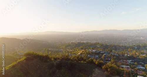 Aerial shot overlooking the homes at the Mulholland Terrace neighborhood, Nichols Canyon, Mount Olympus, during sunset, in The Eastern Santa Monica Mountains, Los Angeles, CA. - Quiet due to Covid-19 photo