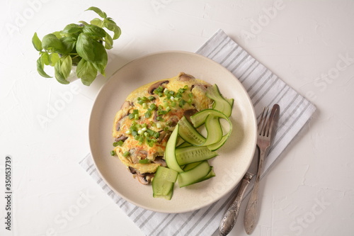 Fresh homemade omelette with mushrooms, green fresh onion and herbs. Healthy diet breakfast