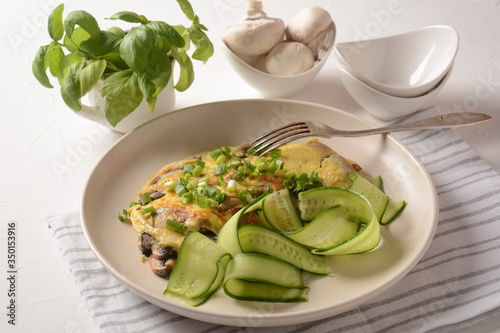 Fresh homemade omelette with mushrooms, green fresh onion and herbs. Healthy diet breakfast