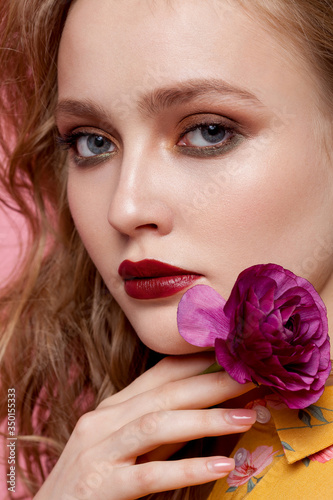 Beauty woman portrait with purple flower  closeup