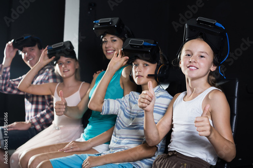 Parents with children in the room of virtual reality