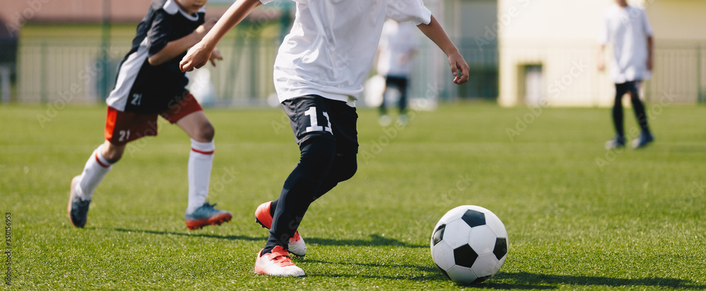 Junior soccer players on a game. European football tournament match between young footballers Junior soccer players on a game. European football tournament match between young footballers