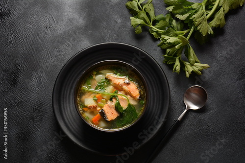 Fototapeta Naklejka Na Ścianę i Meble -  Fresh fish soup on black background