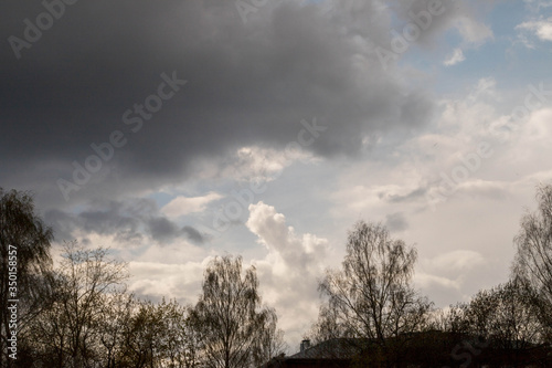 blue sky with white and grey rain clouds