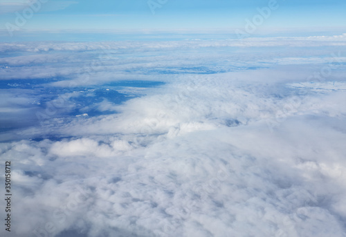 Flight above cumulus clouds in the winter 