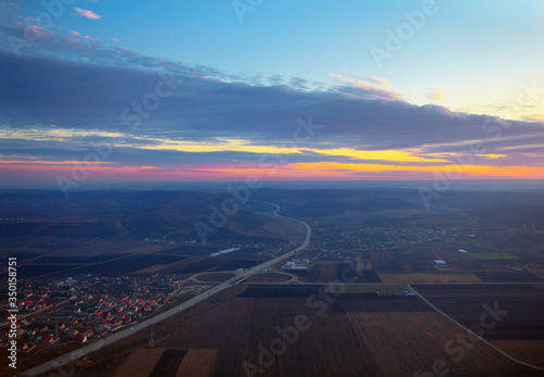 aerial view of highway and agricultural fields in the twilight