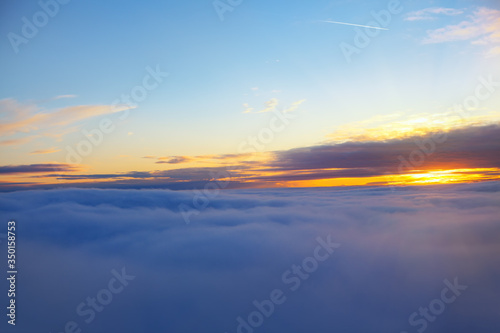 fantastic dusk with aerial view over the clouds