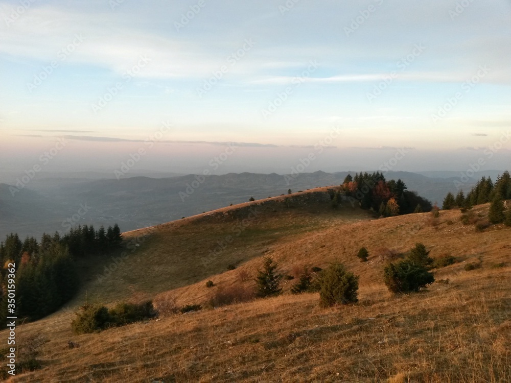 Obraz premium fall season at the mountain with colorfully trees, meadows and hills