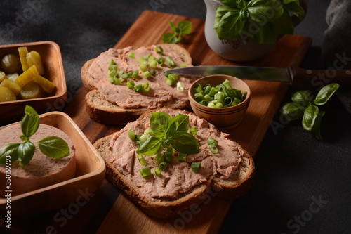 Chicken or goose liver pate sandwiches on a wooden board