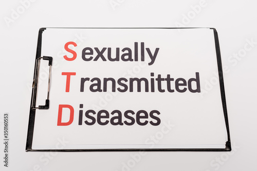 top view of clipboard with sexually transmitted diseases lettering isolated on white