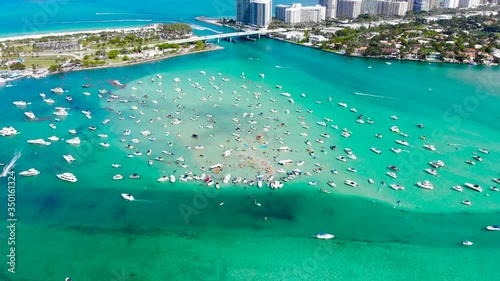 Huge gathering of people at Haulover Sandbar in beautiful sunshine Florida, USA photo