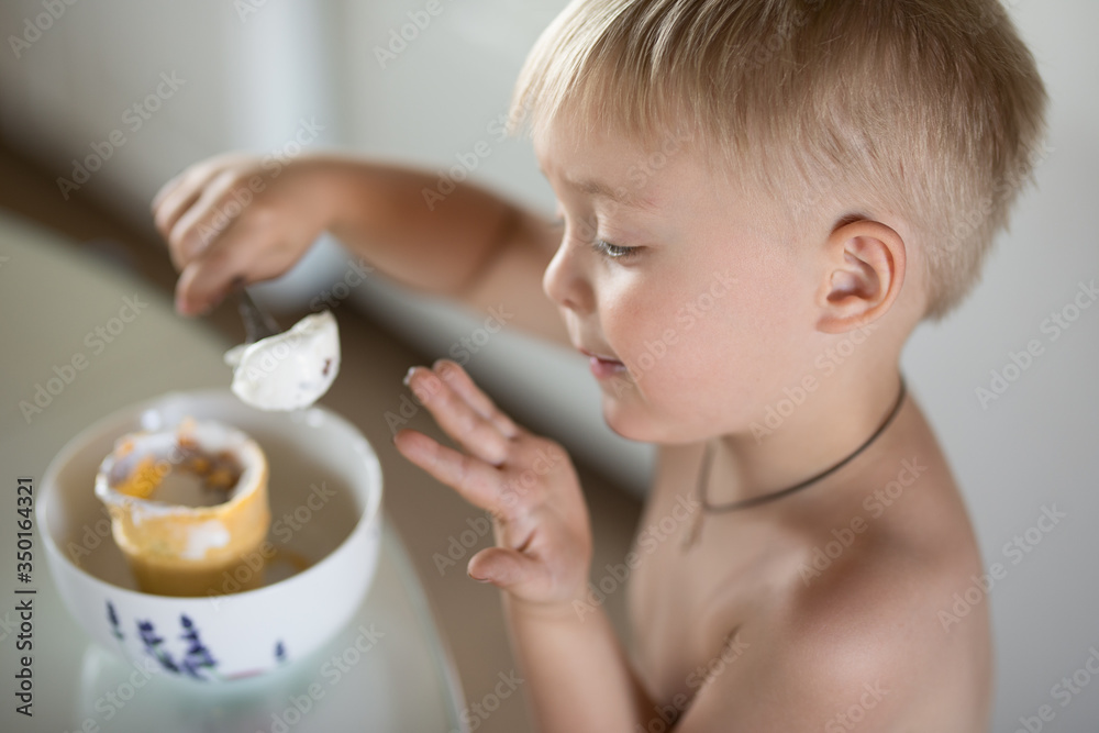 Little boy eats a spoon of ice cream Little boy eats a spoon of ice cream