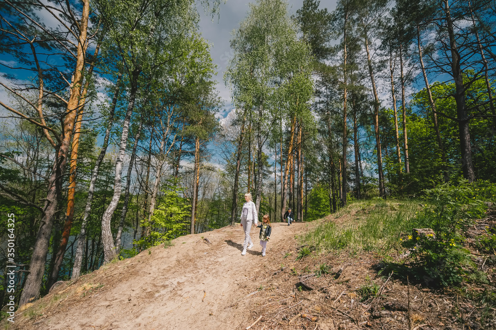 Obraz premium Mother and daughter in forest walking and having fun